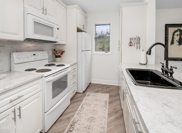 4480 Timber Falls Ct Unit 1507, Vail, CO 81657 - kitchen with white appliances, a sink, decorative backsplash, white cabinetry, and light wood finished floors
