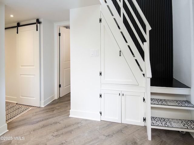 4480 Timber Falls Ct Unit 1507, Vail, CO 81657 - stairs with wood finished floors, a barn door, baseboards, and recessed lighting