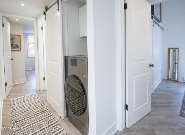 4480 Timber Falls Ct Unit 1507, Vail, CO 81657 - laundry area featuring a barn door, washer / clothes dryer, baseboards, light wood-type flooring, and recessed lighting