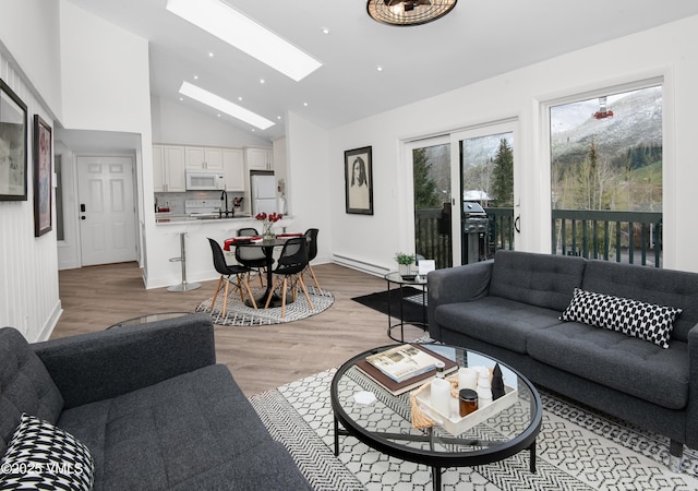 4480 Timber Falls Ct Unit 1507, Vail, CO 81657 - living room featuring vaulted ceiling, a skylight, light wood finished floors, recessed lighting, and baseboards