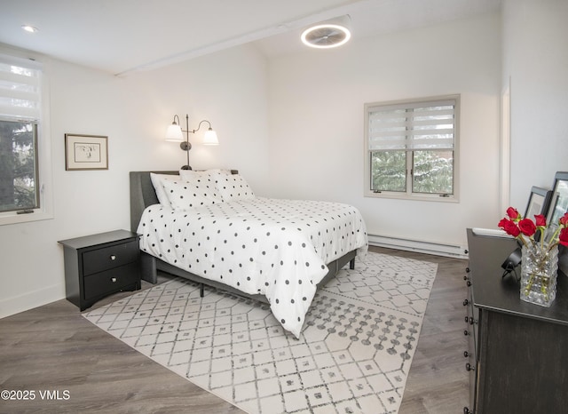 4480 Timber Falls Ct Unit 1507, Vail, CO 81657 - bedroom with a baseboard heating unit, wood finished floors, and baseboards