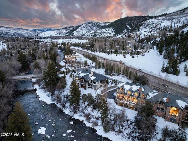 snowy aerial view with a mountain view