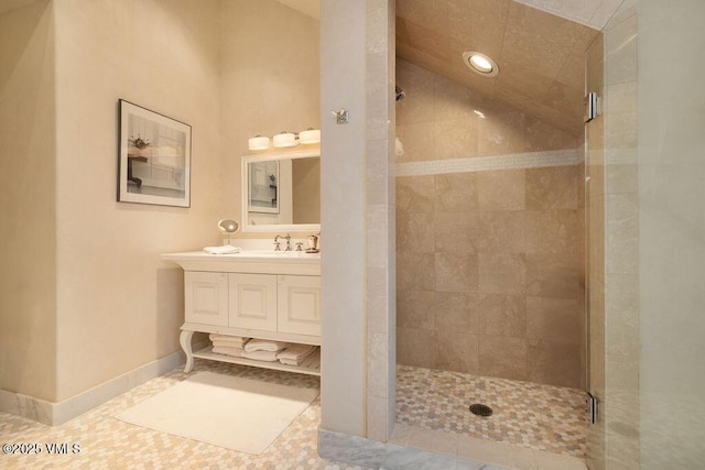 bathroom with tile patterned floors, a shower stall, vanity, and baseboards