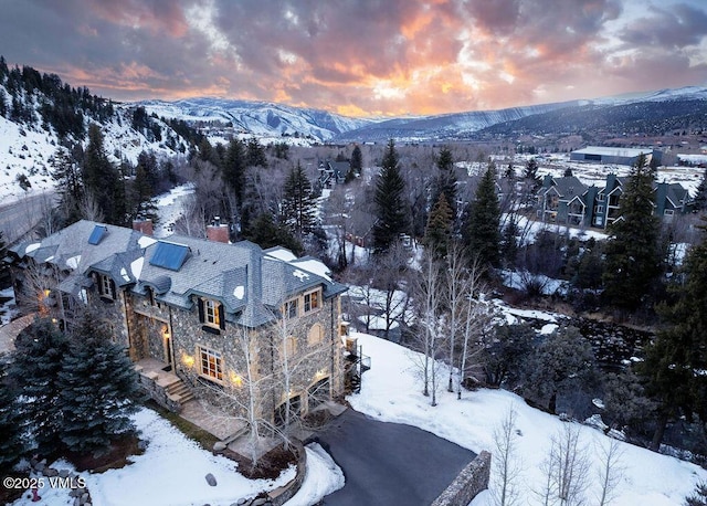 snowy aerial view featuring a mountain view