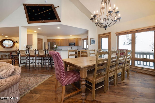 dining space featuring a high ceiling and a chandelier