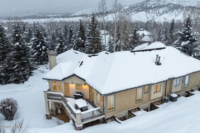 snowy aerial view featuring a mountain view