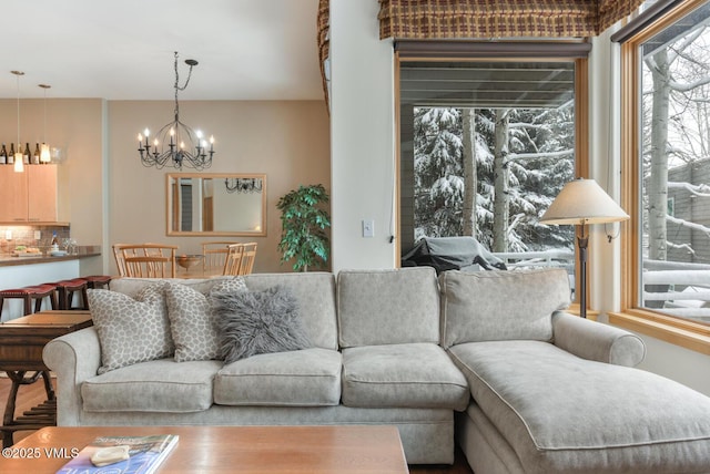 1230 Lions Ridge Loop Unit 2-D, Vail, CO 81657 - living room featuring a chandelier and plenty of natural light