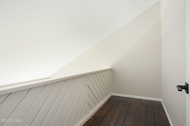 interior space with dark wood-type flooring and baseboards