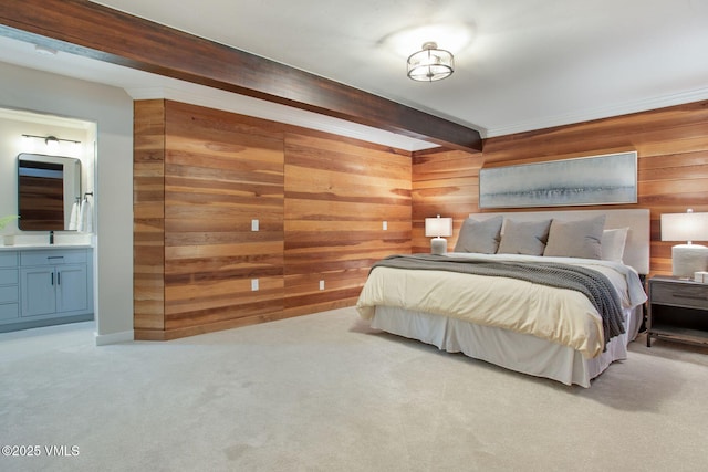 carpeted bedroom featuring wood walls, beamed ceiling, and ensuite bath