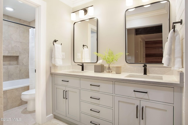 bathroom with double vanity, crown molding, and a sink