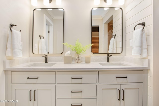 full bathroom featuring ornamental molding, double vanity, and a sink