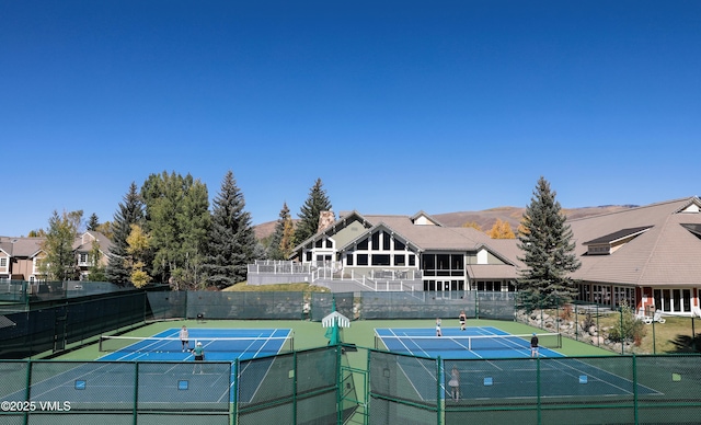 1019 Edwards Village Blvd Unit D16, Edwards, CO 81632 - view of tennis court featuring community basketball court, fence, and a mountain view