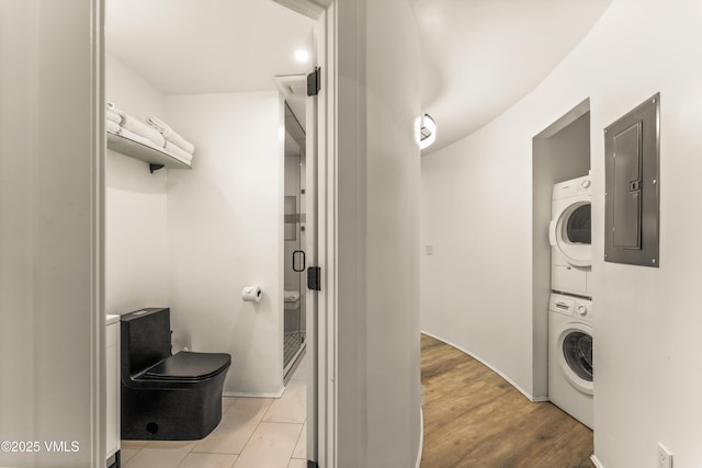 2940 Basingdale Blvd Unit 2, Vail, CO 81657 - laundry area with stacked washer and clothes dryer, electric panel, and baseboards