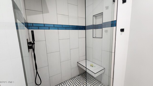 bathroom with a tile shower