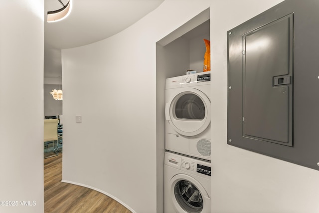 2940 Basingdale Blvd Unit 2, Vail, CO 81657 - clothes washing area featuring estacked washer and dryer, electric panel, and wood finished floors