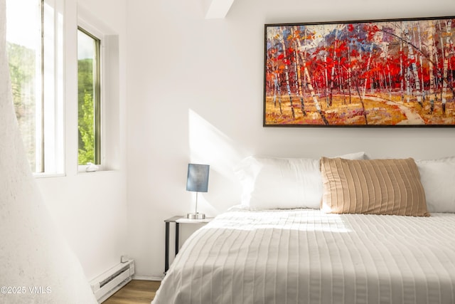 2940 Basingdale Blvd Unit 2, Vail, CO 81657 - bedroom featuring a baseboard radiator, multiple windows, and wood finished floors