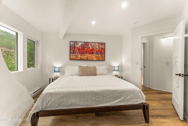 2940 Basingdale Blvd Unit 2, Vail, CO 81657 - bedroom featuring baseboard heating, wood finished floors, recessed lighting, and beam ceiling