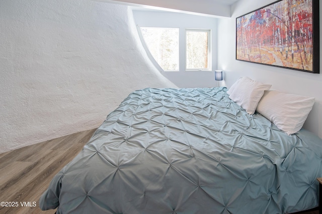 bedroom featuring wood finished floors