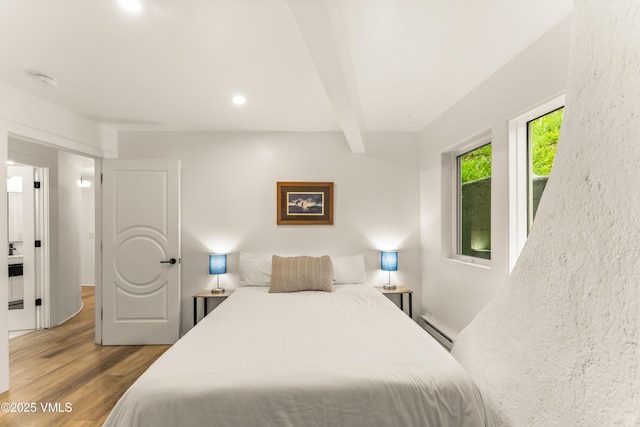 2940 Basingdale Blvd Unit 2, Vail, CO 81657 - bedroom featuring wood finished floors, a baseboard heating unit, beam ceiling, and recessed lighting