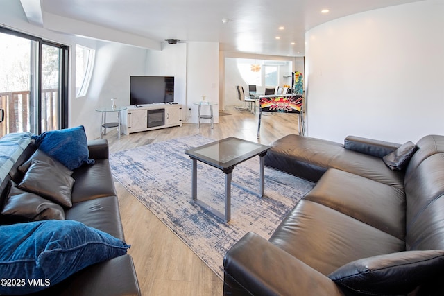 living area with recessed lighting and light wood-style flooring