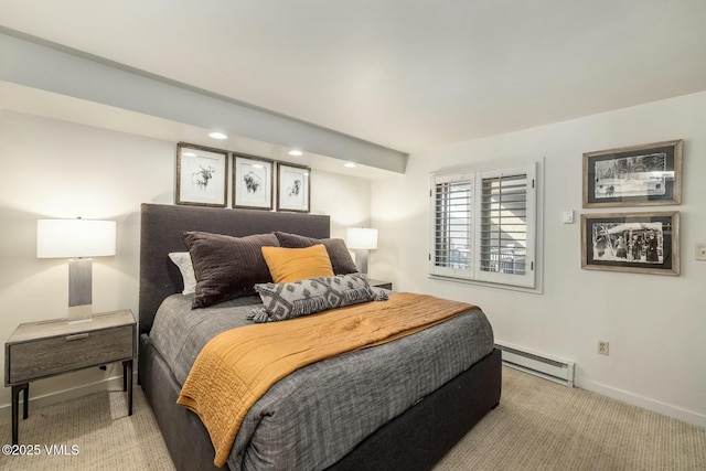 bedroom with baseboards, baseboard heating, and light colored carpet