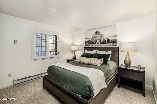 bedroom with a baseboard heating unit, carpet floors, and baseboards