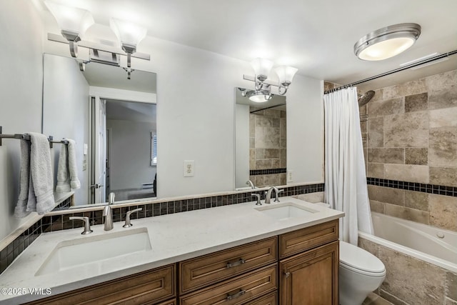 bathroom featuring a sink, backsplash, and toilet