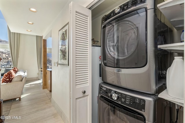 laundry room with stacked washer / dryer, laundry area, light wood-style flooring, and recessed lighting