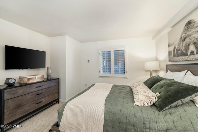 bedroom featuring carpet flooring and baseboards