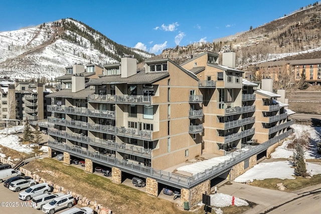 snow covered property with a mountain view