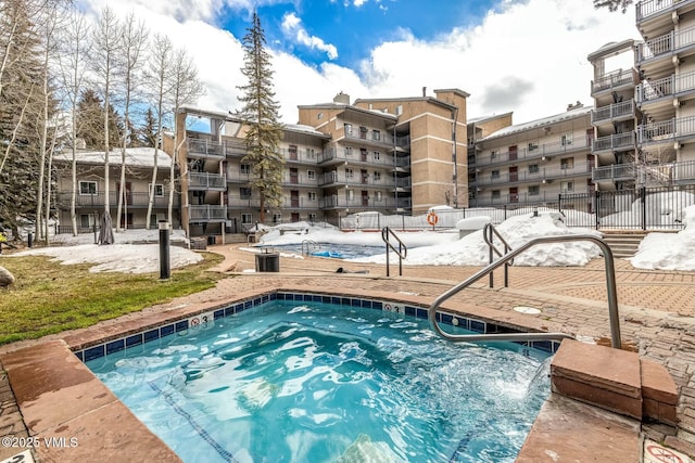 view of swimming pool with a community hot tub