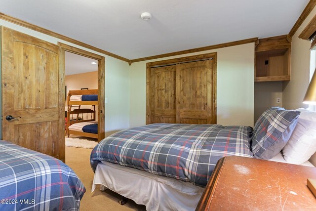 bedroom with ornamental molding and carpet