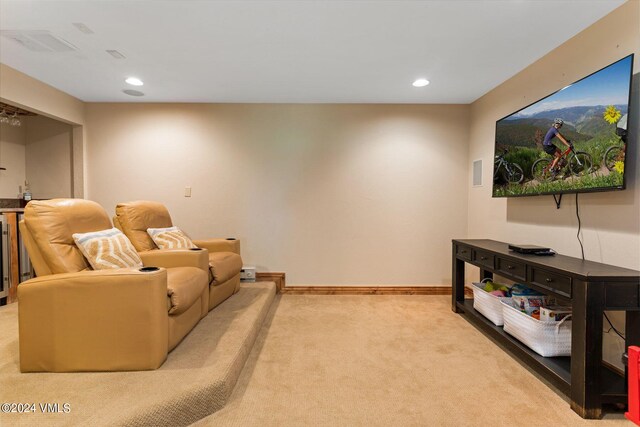 home theater room with light colored carpet