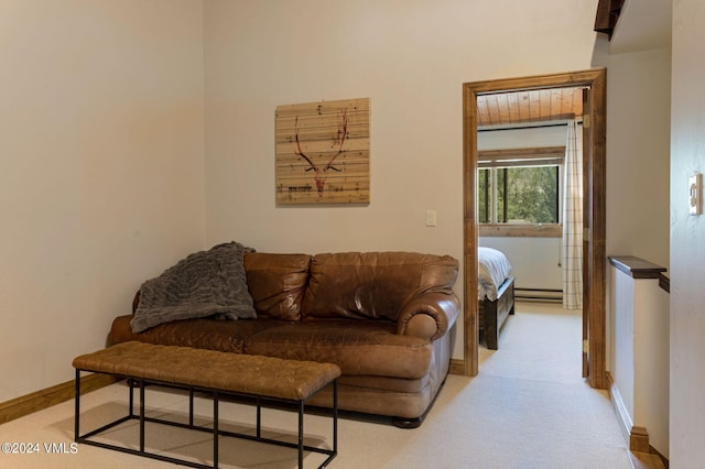 living room featuring a baseboard heating unit and light colored carpet