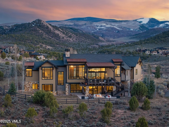 2682 E Haystacker Dr, Eagle, CO 81631 - back of property featuring a chimney, stone siding, and a mountain view