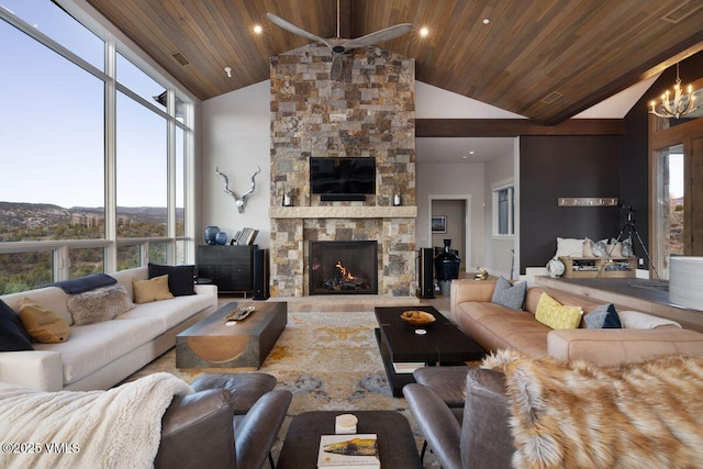 2682 E Haystacker Dr, Eagle, CO 81631 - living area with wood ceiling, high vaulted ceiling, a stone fireplace, ceiling fan, and a chandelier