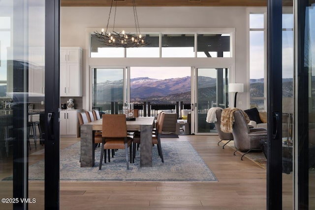 2682 E Haystacker Dr, Eagle, CO 81631 - dining space featuring a mountain view, healthy amount of natural light, a chandelier, and light wood-style floors