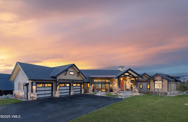 2682 E Haystacker Dr, Eagle, CO 81631 - view of front of home with stone siding, a front lawn, asphalt driveway, and a chimney