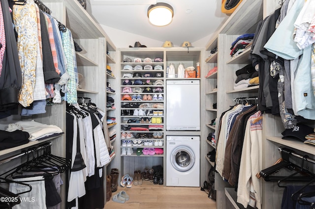 2682 E Haystacker Dr, Eagle, CO 81631 - spacious closet with stacked washer / dryer, wood finished floors, and vaulted ceiling