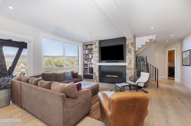 2682 E Haystacker Dr, Eagle, CO 81631 - living area featuring a fireplace, light wood-style flooring, stairs, and recessed lighting