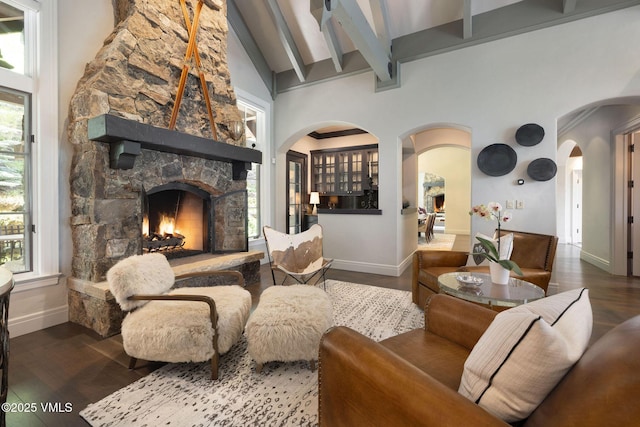 1724 Paintbrush, Avon, CO 81620 - living room with wood finished floors, a stone fireplace, arched walkways, and baseboards