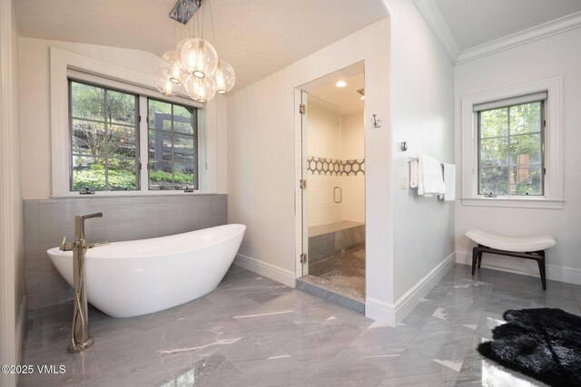 1724 Paintbrush, Avon, CO 81620 - bathroom with marble tiled floors, a freestanding tub, a chandelier, a stall shower, and ornamental molding