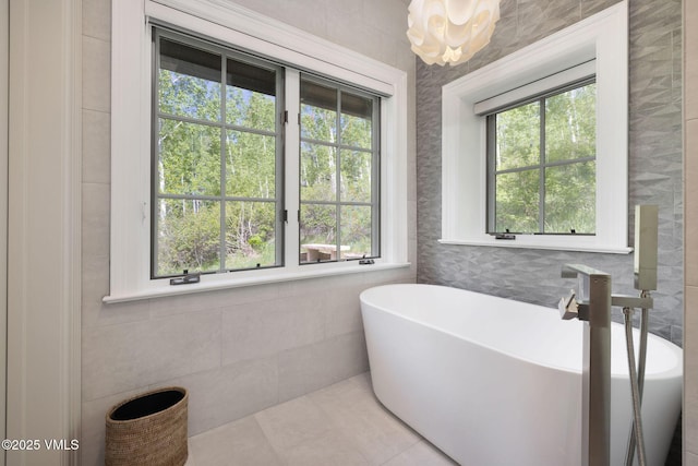 1724 Paintbrush, Avon, CO 81620 - full bathroom featuring tile walls, a freestanding tub, tile patterned flooring, and a chandelier