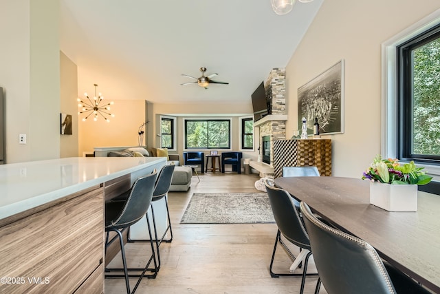 11 Spruce Cir, Edwards, CO 81632 - dining room with light wood-style floors, a chandelier, and a fireplace