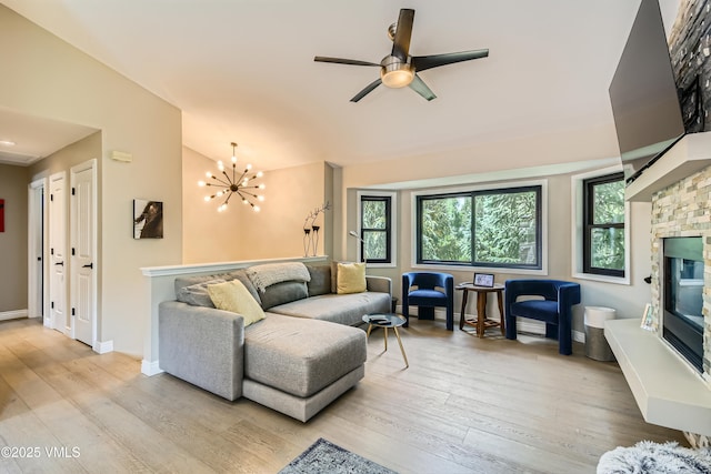 11 Spruce Cir, Edwards, CO 81632 - living area with light wood-style flooring, vaulted ceiling, ceiling fan, a chandelier, and a fireplace