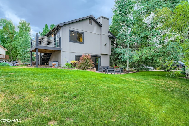 11 Spruce Cir, Edwards, CO 81632 - back of house featuring stairway, a deck, outdoor lounge area, and a yard
