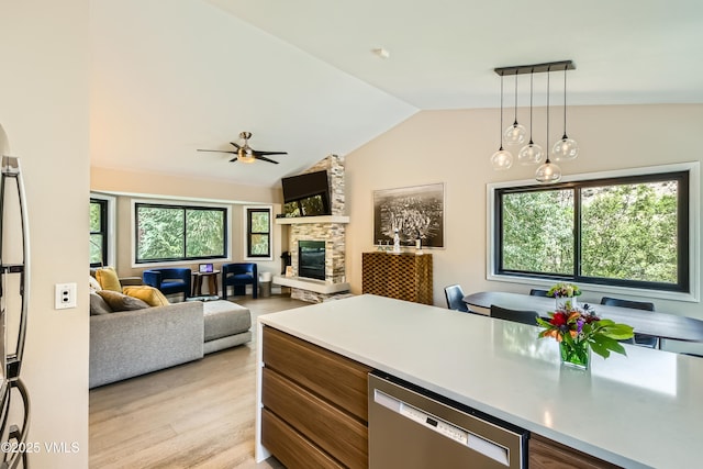 11 Spruce Cir, Edwards, CO 81632 - kitchen featuring dishwasher, a stone fireplace, lofted ceiling, pendant lighting, and ceiling fan