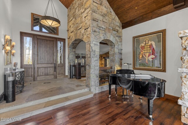 entryway with wood ceiling, high vaulted ceiling, dark wood-type flooring, and ornate columns