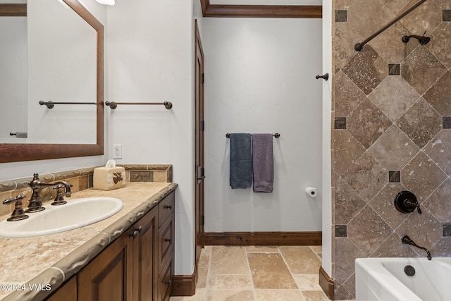 bathroom with vanity and tiled shower / bath