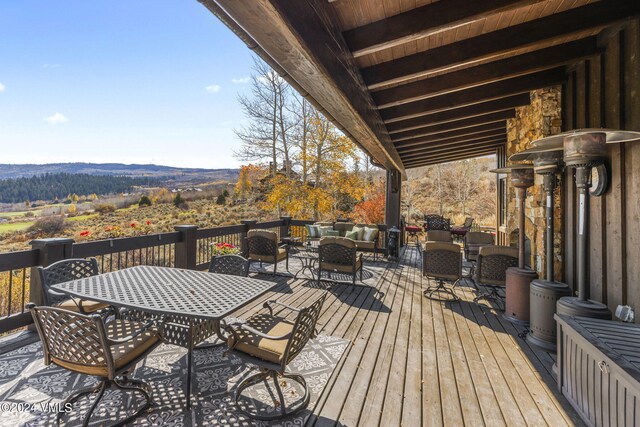 wooden terrace featuring outdoor lounge area